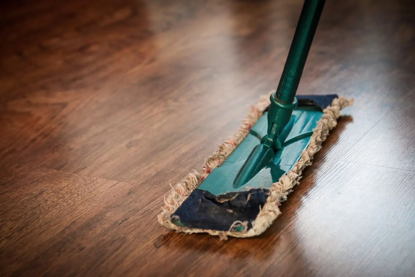 Stock photo of a flat mop on a dark hardwood floor
